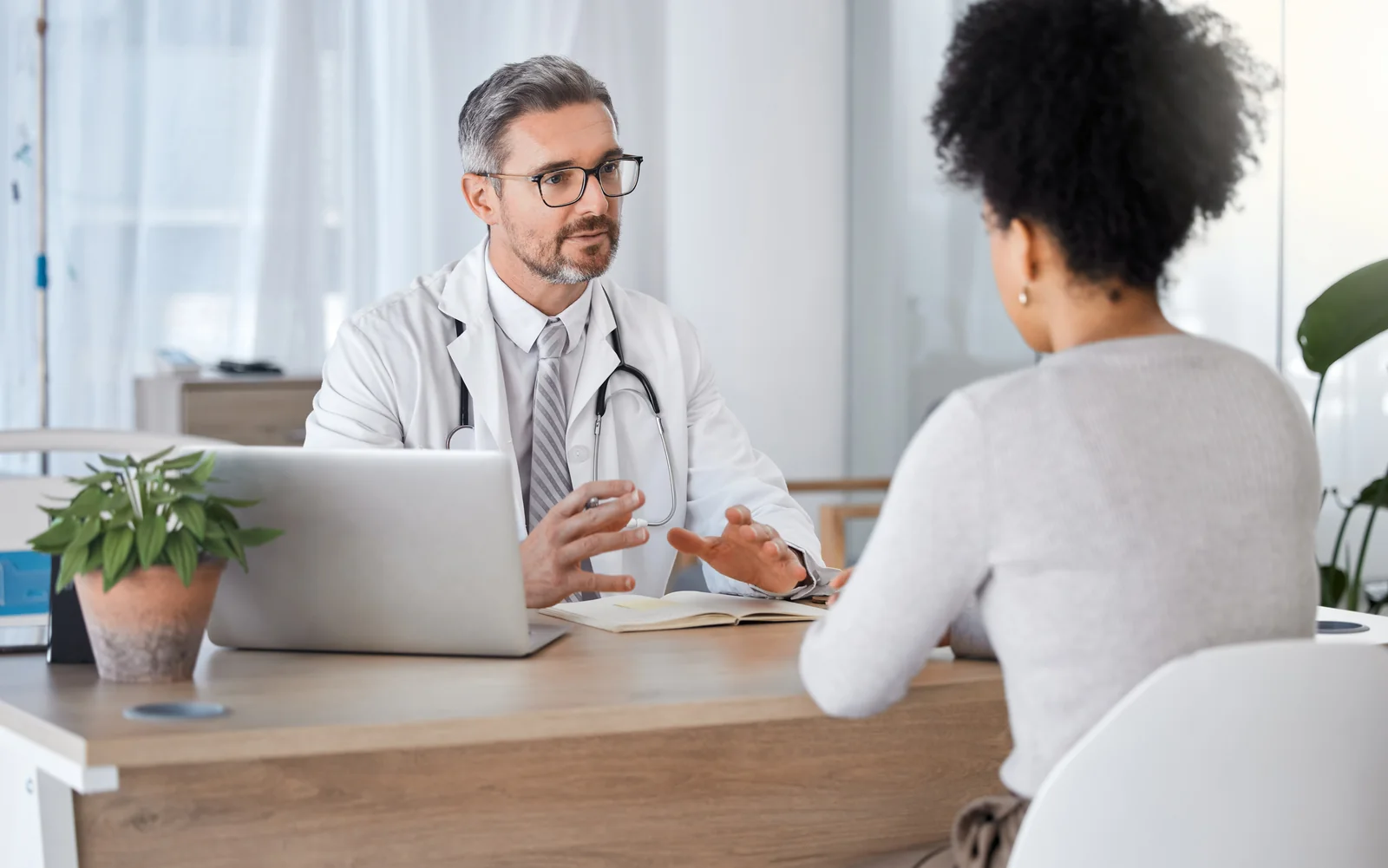 A physician in conversation with a patient in a bright clinic office